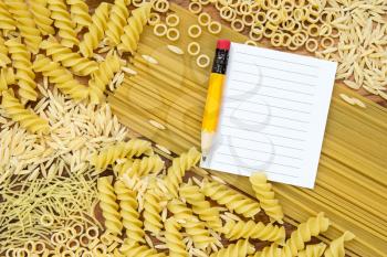 Uncooked pasta and blank paper for recipe 