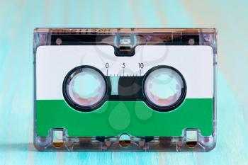Retro audio cassette  on the blue wooden background