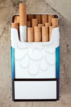 Pack of cigarettes with cigarettes sticking out. Copy space for your text.