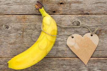Healthy eating concept. Fresh banana fruit with heart shaped tag for your text.