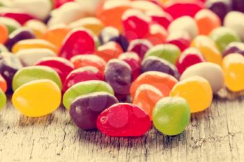 Mixed colorful candies on wooden background