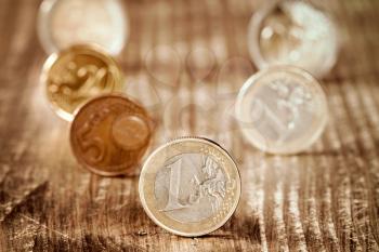Euro coins. Euro money. Euro currency. Different euro coins on wooden background. Money concept.