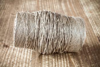 Skein jute twine on old wooden table background