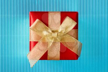 Gift box on blue corrugated paper background
