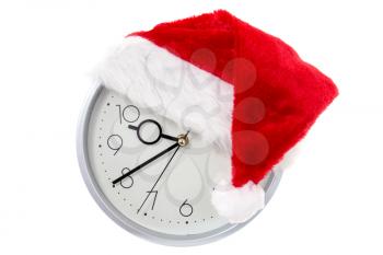 Wall clock with Christmas Santa hat. Isolated on white background