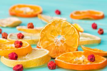 Sliced citrus fruits and rowan berry close up