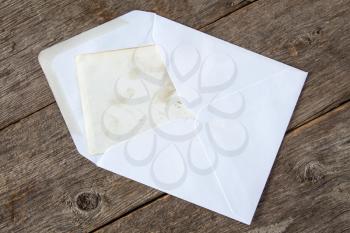   White envelope with blank card on wooden background