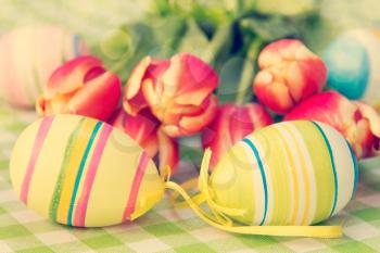 Easter eggs and fresh spring tulips. Pastel color style filter.