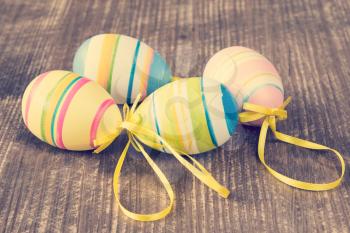 Four colorful easter eggs on wooden background