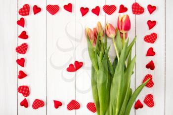 Valentine's day background with tulip's bouquet and many decorative hearts
