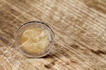 Two Euro coin on the wooden table surface