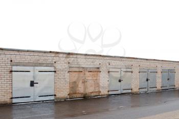 Row of garage doors at parking area for townhouses. Copy-space.