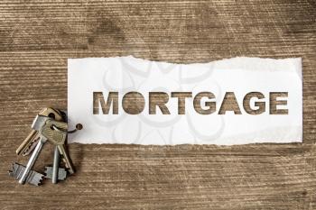 Keys with lettering MORTGAGE. House building, loan, real estate or buying a new home concept