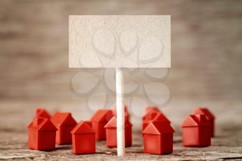 Blank sign with mini red houses,concept for real estate