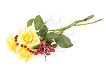 Rosary and yellow roses,isolated on white background