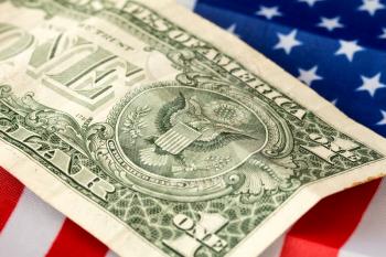 One Dollar banknote over the flag of the United States
