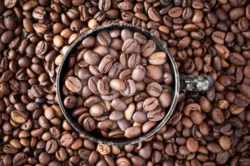 Cup of coffee on coffee beans background 