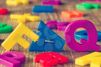 FAQ spelled out with Colorful Fridge Magnets Letters
