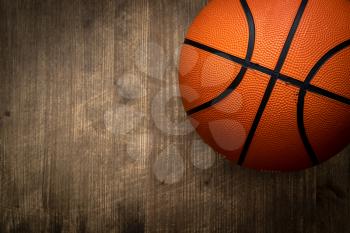 Basket ball on dark wood background