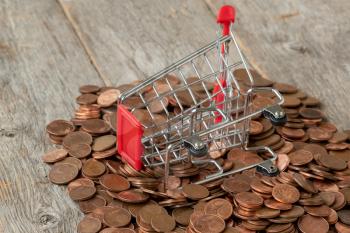 Overturned shopping cart and scattered coins