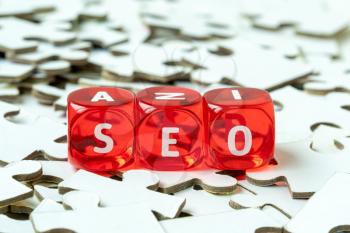  Pile of jigsaw puzzle with word SEO on plastic cubes