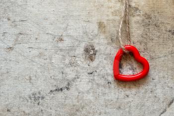 Single cute red heart hanging on the string. Copy space.