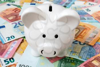 Piggy money box with euro cash close-up. Investment or savings concept