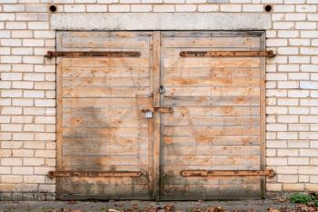 Wooden garage door with padlock and hinges
