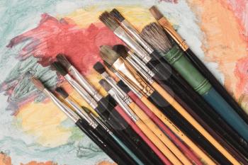 Vintage tools brushes on artistic painting background 