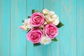 Decoration artificial flower in the pot on table.Top view.