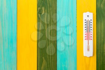 Thermometer on the wooden wall, concept of hot weather