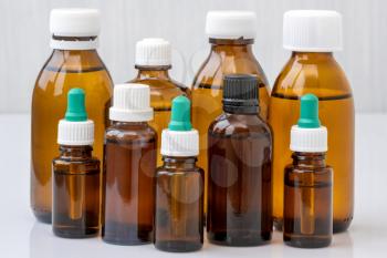Brown glass bottles with medicine or essential oil. Close up view.
