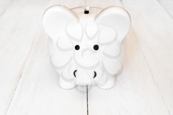 Front view of white piggy bank. Business and finance concept