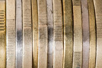 Various coins in a horizontal column, close up