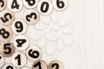 Metal numbers on white wood background. Copy space for text or advertisement