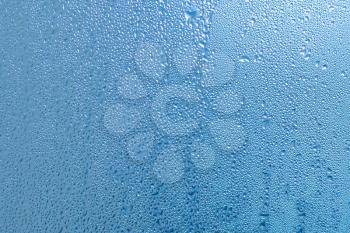Background of natural water condensation, window glass with high air humidity.