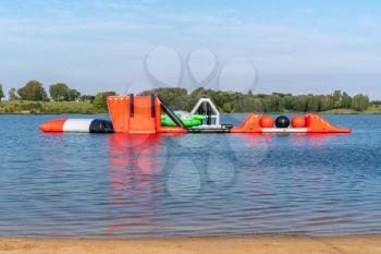 Bouncy castle on the lake. Inflatable playground for children in the lake