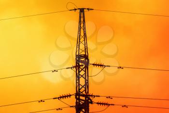 Silhouette of High voltage pylon or High voltage tower on the orange sunset 