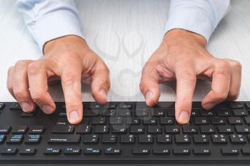 Businessman using computer. Picture of man hands typing on keyboard