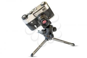 Retro film camera on mini tripod, isolated on white background