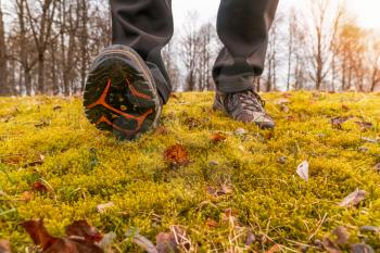 Man walking in comfortable hiking shoes. Active way of life, walk in the spring forest.