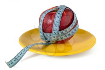 Diet concept with healthy apple and measure tape in the dinner plate