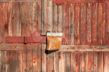 Old wooden garage gate with faded paint 