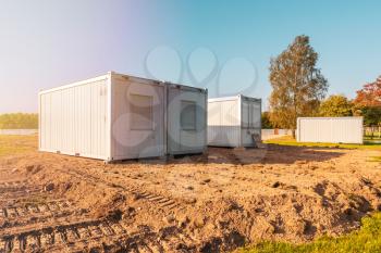 Construction trailers for workers at the new construction site. Mobile containers and cabins base for the site manager and employees.
