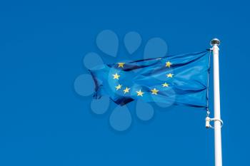 European Union flag flying in front of bright blue sky