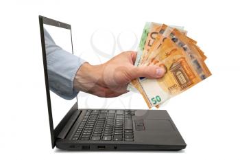 Hand holding Euro banknotes coming out from computer screen.Concept registration for  government aid, for people affected by the covid-19 or coronavirus crisis.
