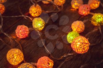 Colorful Christmas LED lights on wooden background