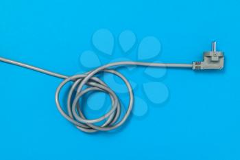 Electric cable with plug on a blue background