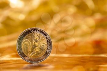 Two Euros on a gold background with nice bokeh