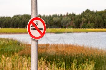 An outdoor Smoke-Free sign with nature background